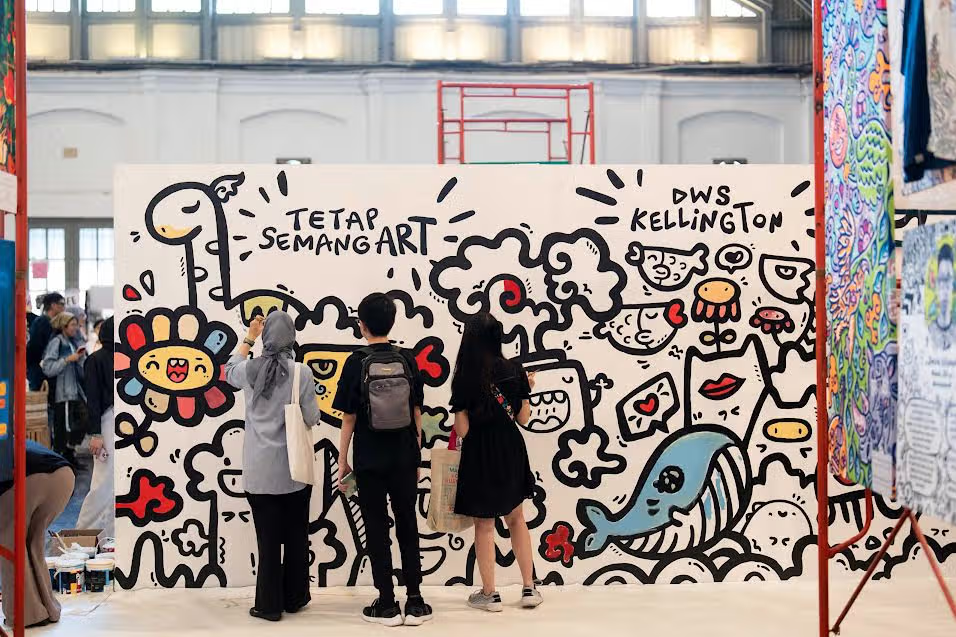 People admiring colorful wall art.